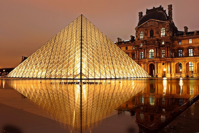 A night-time view of the Louvre Museum in Paris