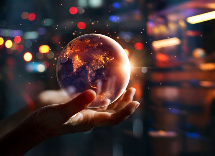 A crystal globe in an outstretched hand and backlit by electric lights: The future for Network Managers is automated – and regulated