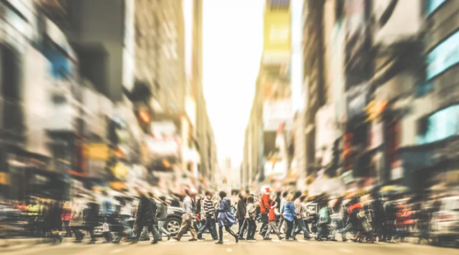 Commuters crossing a busy city street